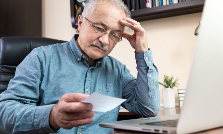 Person reviewing financial information on a laptop, illustrating fraud and money laundering investigations