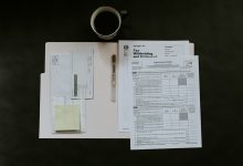 Generic financial documents illustration for a money-laundering enforcement article. Photo by Kelly Sikkema on Unsplash.